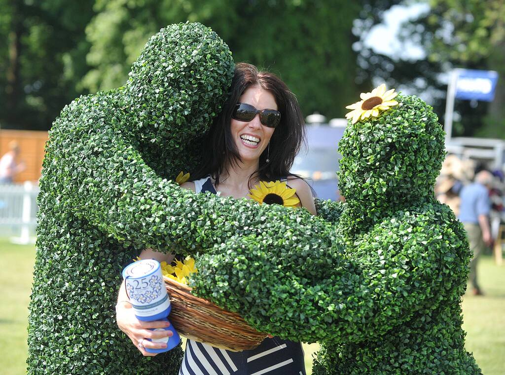The Human Hedges hug a lady at a Flower Show in Cumbria.